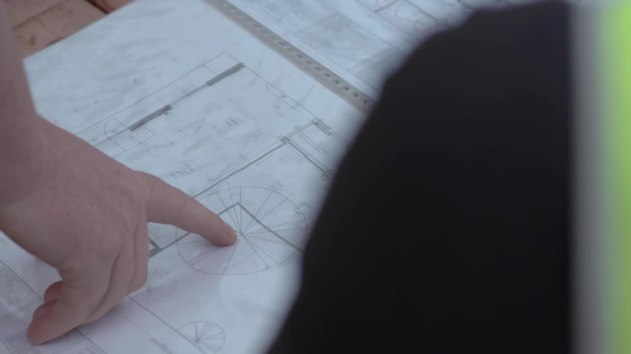 Estimator pointing to details on a drawing set
